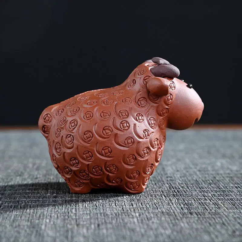 Brown ceramic Sheep figurine from Peaceful Ram, ideal for feng shui tea pets guide