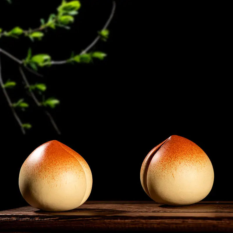 Two peach-shaped ceramic figurines for tea pet guide and feng shui practices