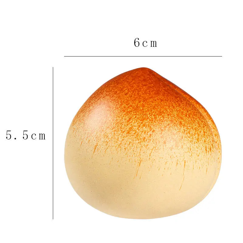 Peach-shaped ceramic ornament tea pet guide for tea ritual techniques and feng shui practices