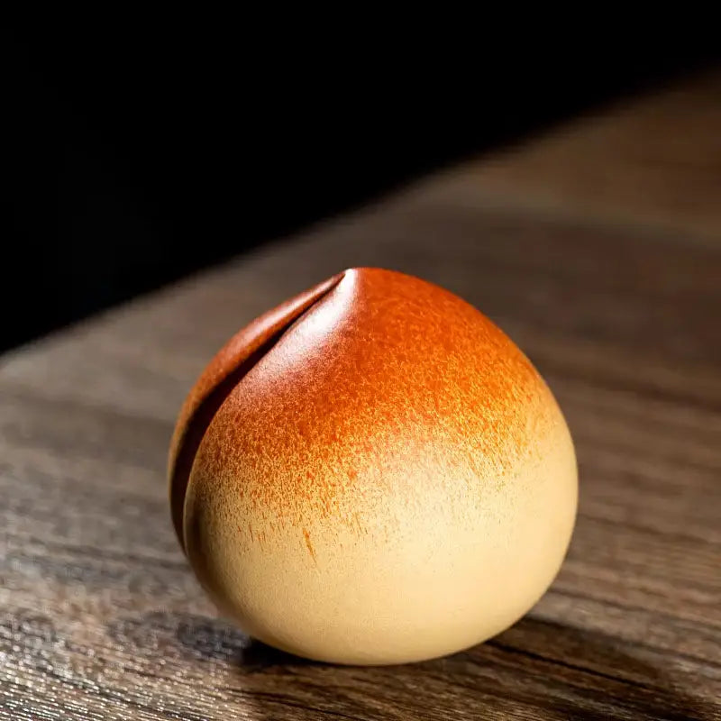 Ceramic peach-shaped ornament tea pet for tea ritual techniques and feng shui practices
