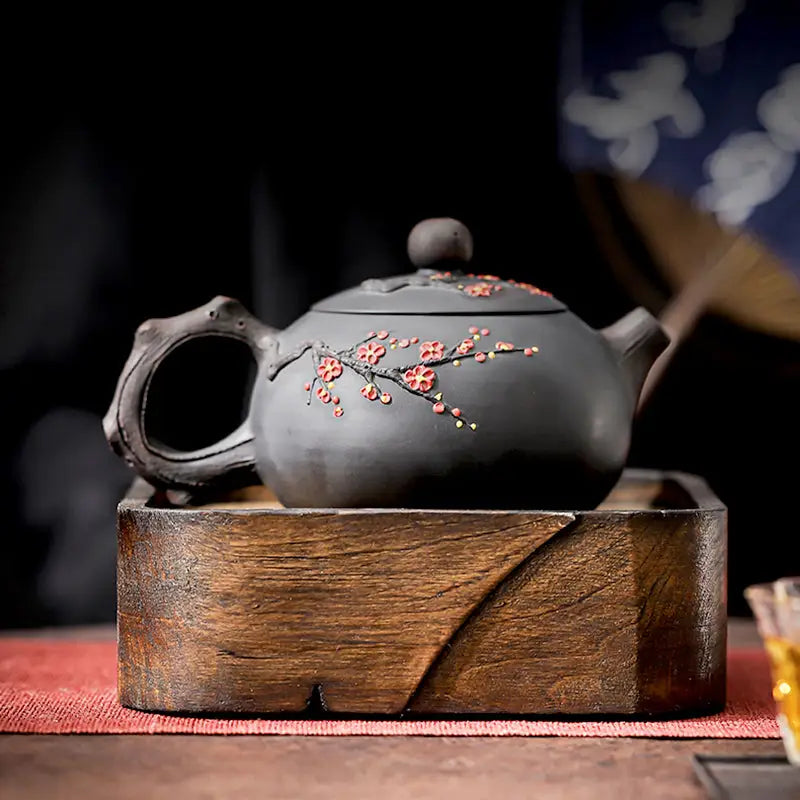 Dark Yixing Zisha teapot with floral Plum Blossom design for elegant teapots collection