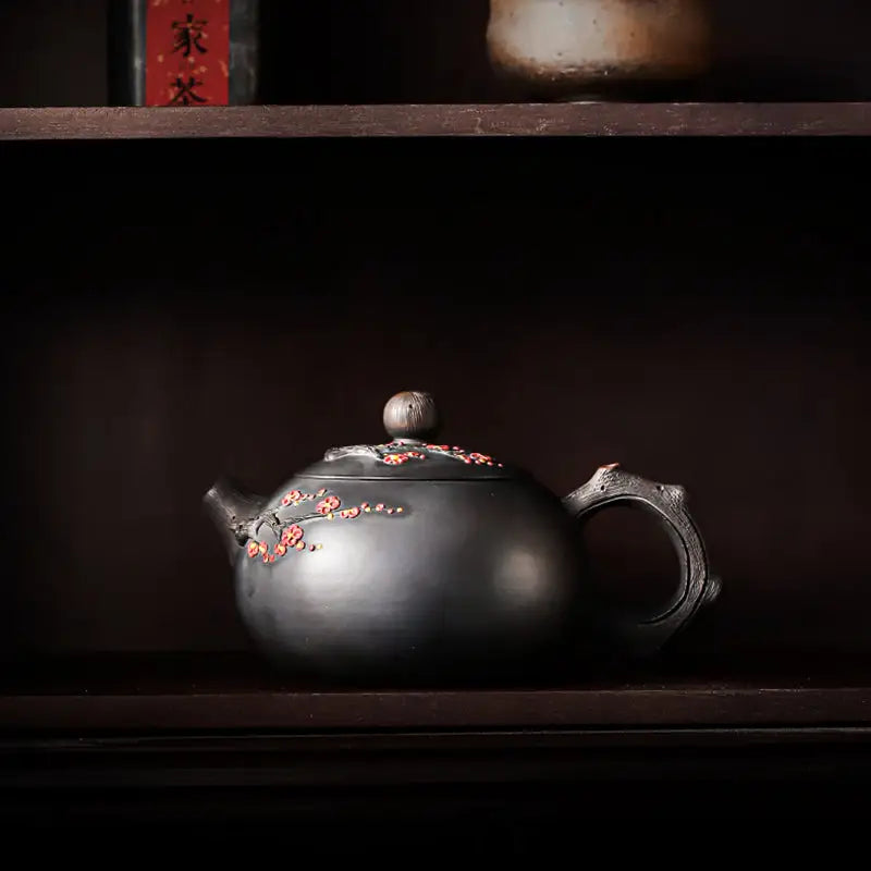 Dark ornate yixing zisha teapot with floral accents from Plum Blossom collection