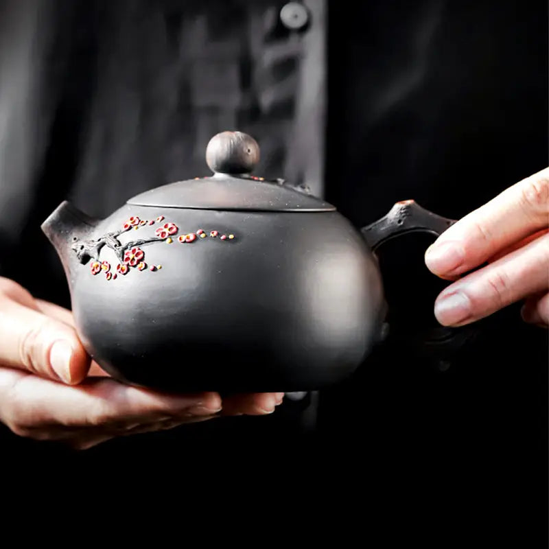 Black Yixing Zisha teapot with floral Plum Blossom design for elegant teapots collection