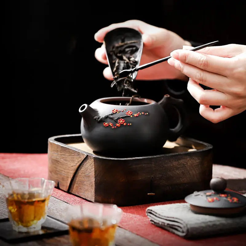 Dark Yixing Zisha teapot with floral Plum Blossom design for traditional teapots