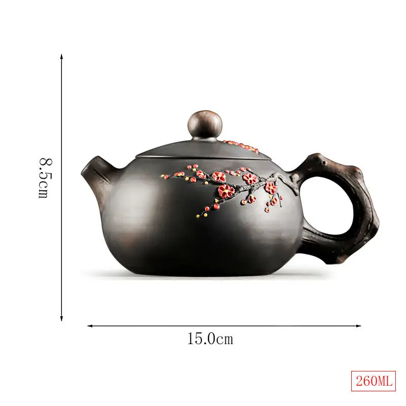 Dark ceramic Yixing Zisha Plum Blossom teapot with floral accents for traditional tea brewing