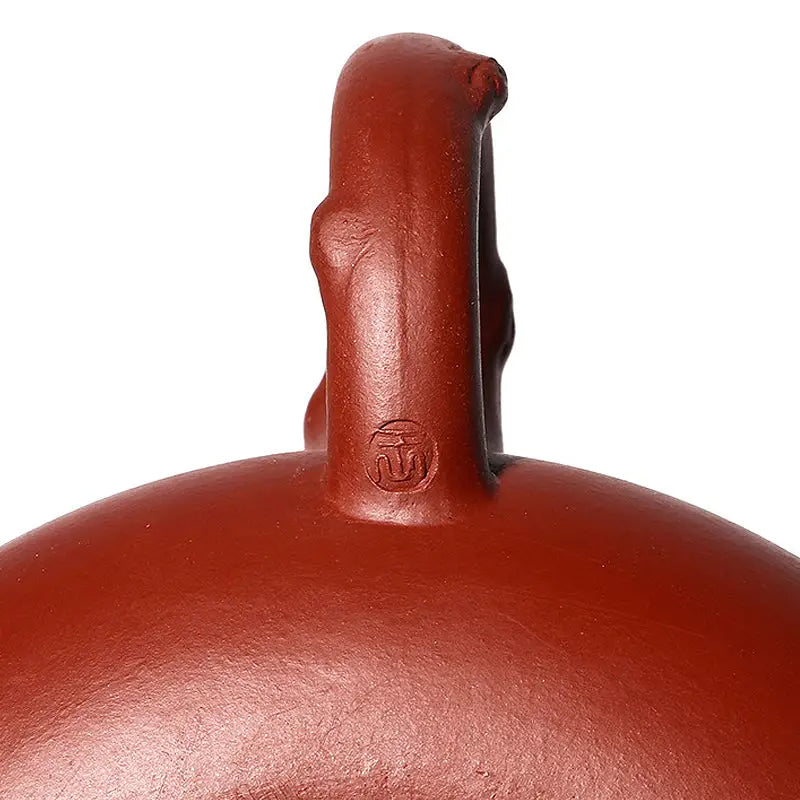 Handcrafted Yixing Zisha ceramic vessel with handle featuring Plum Blossom motif for Gongfu tea