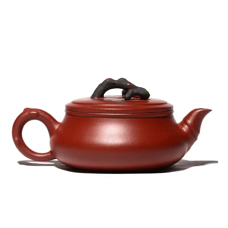 Reddish-brown handcrafted Yixing Zisha Gongfu tea teapot with Plum Blossom motif and twig handle