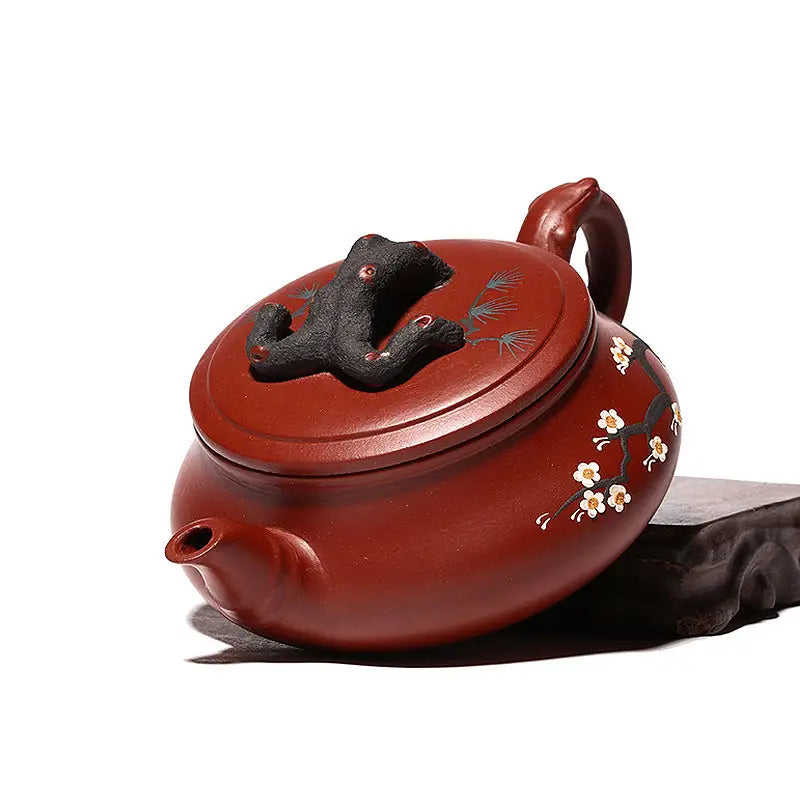 Reddish-brown handcrafted Yixing Zisha gongfu tea teapot with plum blossom motif and frog lid