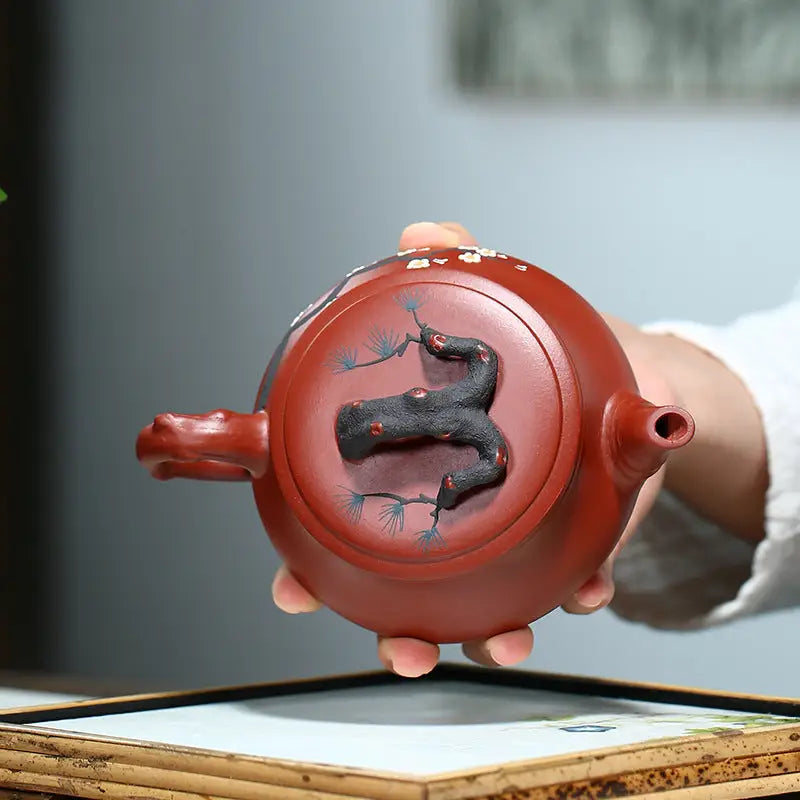 Reddish-brown handcrafted Yixing Zisha teapot with Plum Blossom motif for Gongfu tea