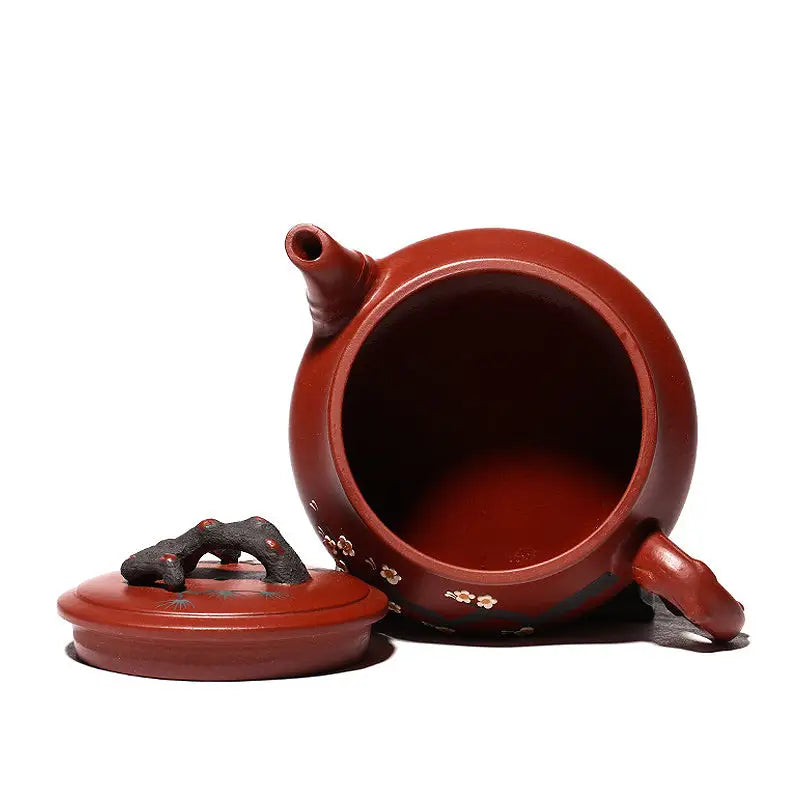 Reddish-brown handcrafted yixing zisha gongfu tea teapot with plum blossom motif