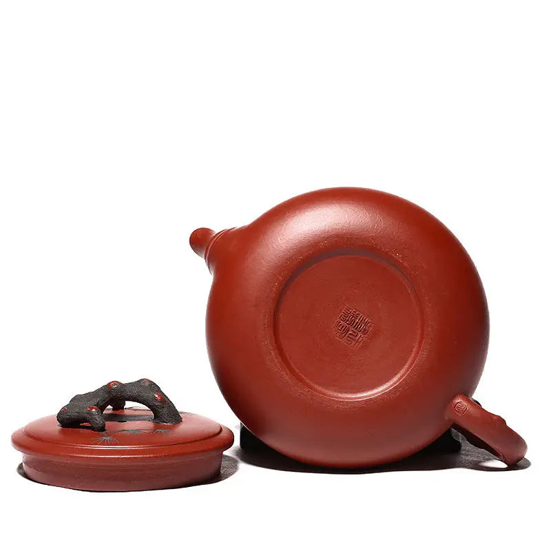 Reddish-brown handcrafted Yixing Zisha teapot with lid featuring Plum Blossom motif for Gongfu tea