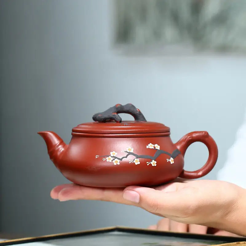 Reddish-brown handcrafted Yixing Zisha teapot with Plum Blossom motif and floral design