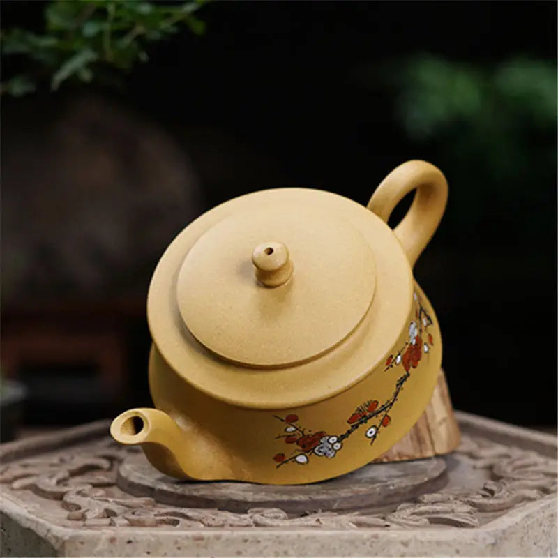 Tan ceramic teapot with floral design from the Plum Flower tea set, perfect for brewing tea