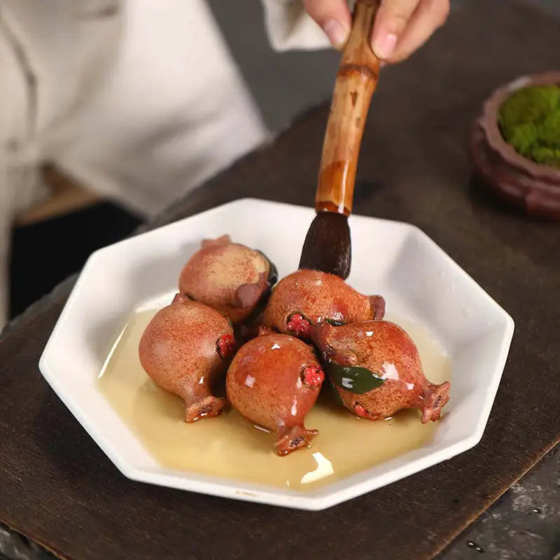 Glazed pomegranate-shaped candies from Pomegranate Blessing, perfect for feng shui tea pets