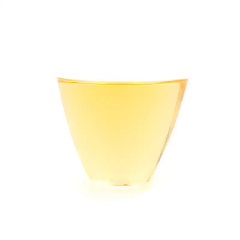Trapezoidal glass of yellow liquid for Premium Jasmine Magnolia Dancong Shuixian Oolong