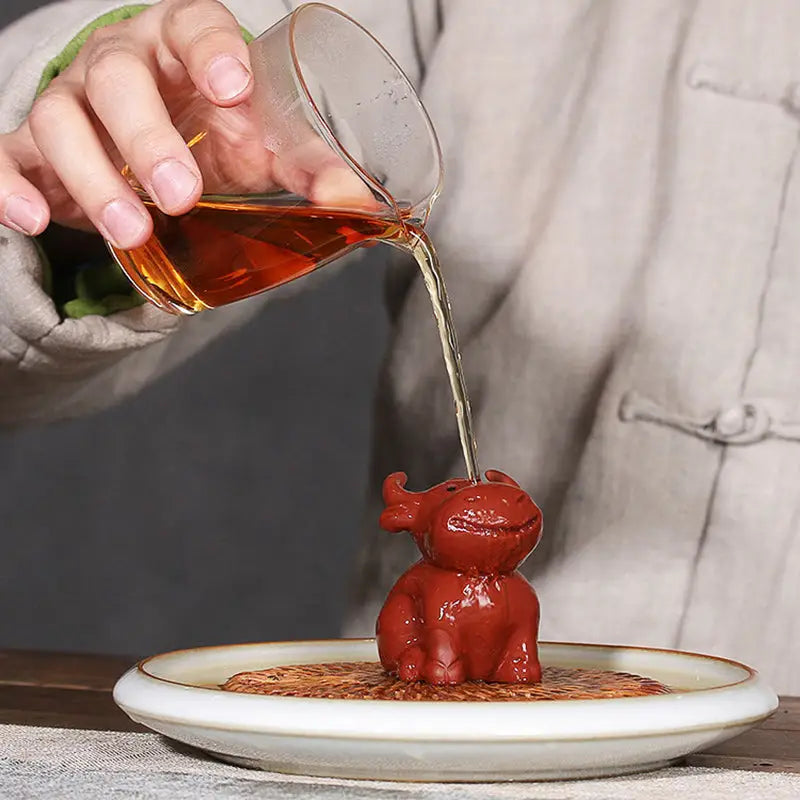 Red ceramic elephant tea pet from Prosperhorn, ideal for feng shui earth element, tea pet guide