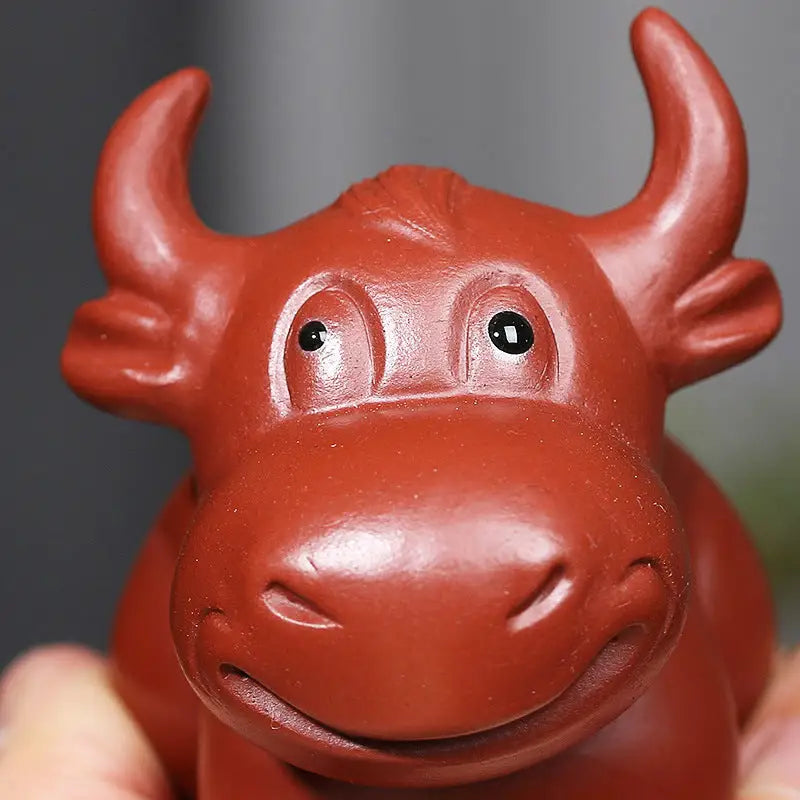 Reddish-brown ceramic bull figurine Prosperhorn tea pet guide yixing zisha feng shui earth element