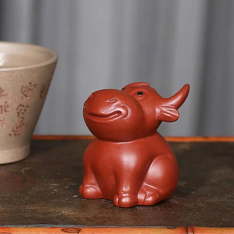 Reddish-brown ceramic hippo figurine from Prosperhorn tea pet guide Yixing Zisha feng shui earth element