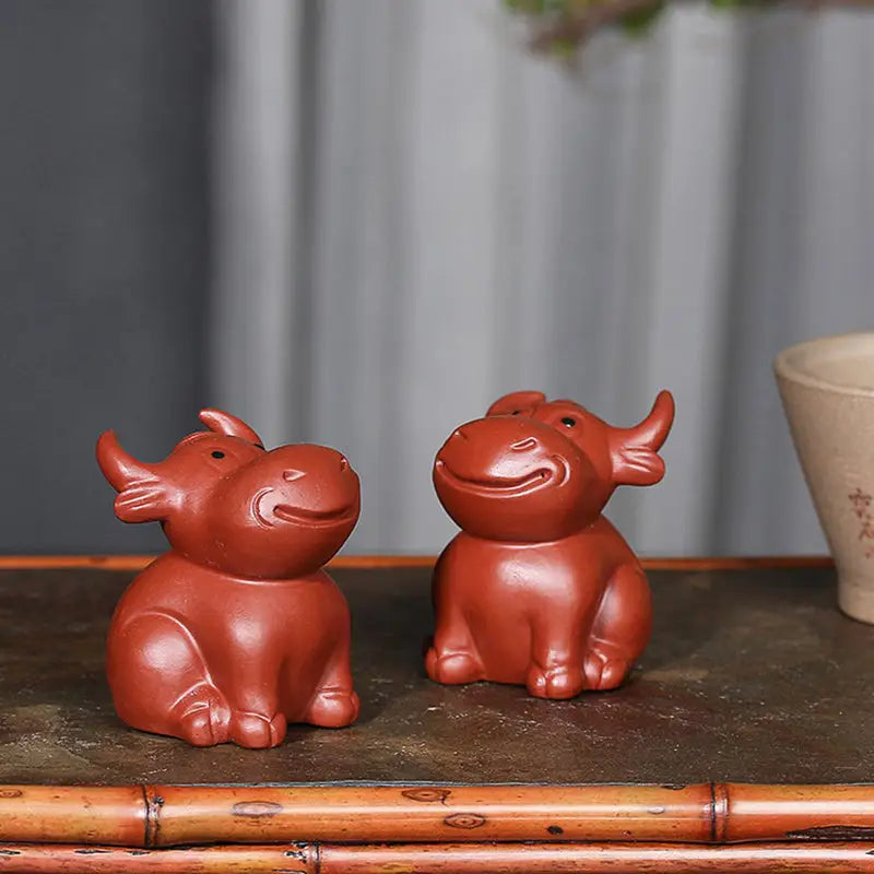 Brown ceramic ox figurines from Prosperhorn, ideal for feng shui earth element decor
