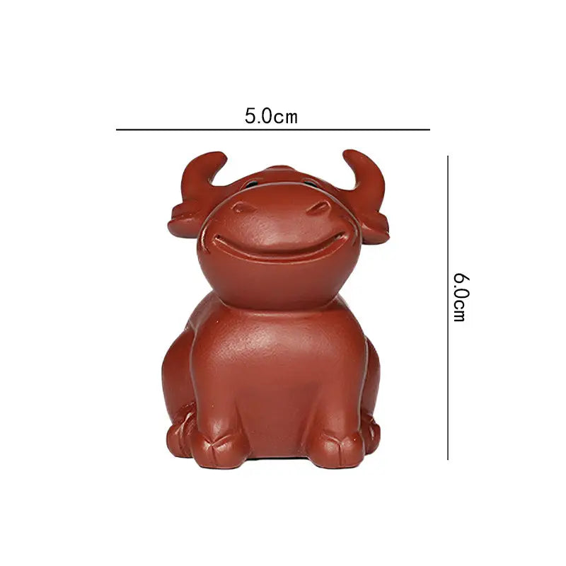 Brown ceramic ox figurine from Prosperhorn tea pet guide, Yixing Zisha, feng shui earth element