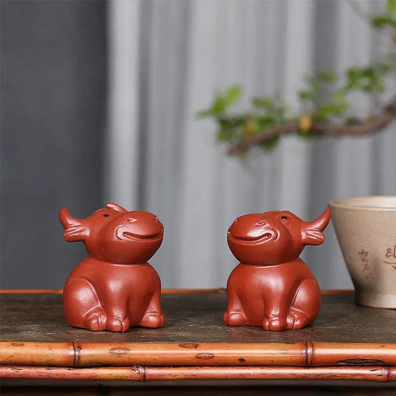 Brown ceramic ox figurines from Prosperhorn, perfect as tea pet guide or feng shui earth element