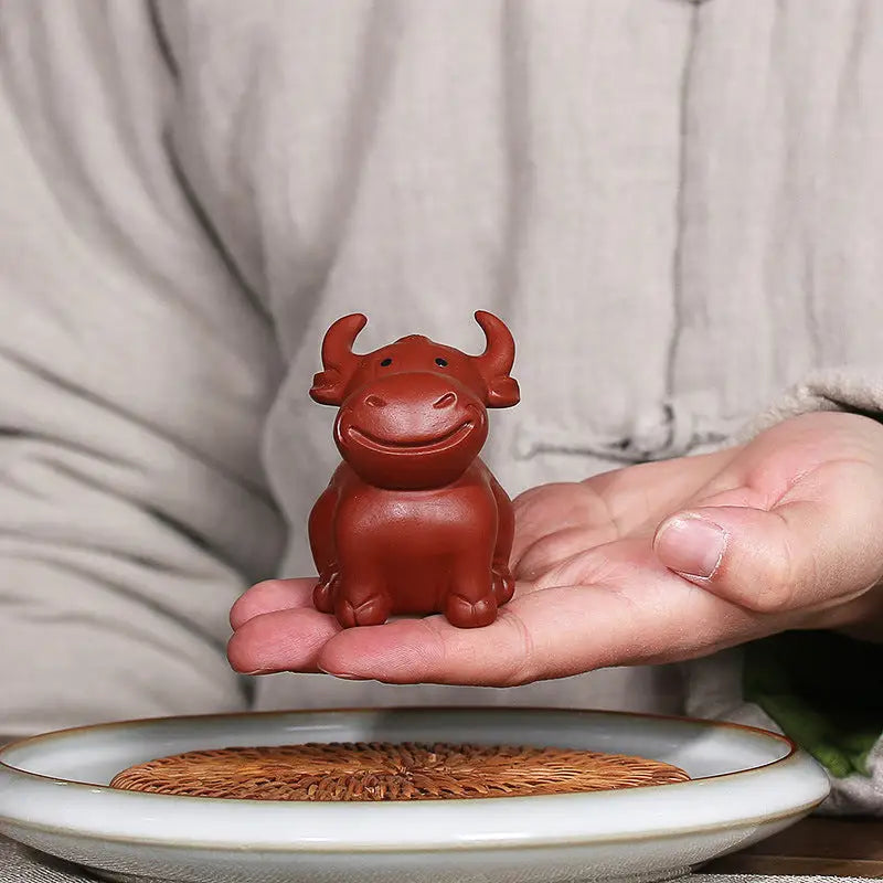 Smiling brown ceramic Prosperhorn bull tea pet, Yixing Zisha Feng Shui earth element