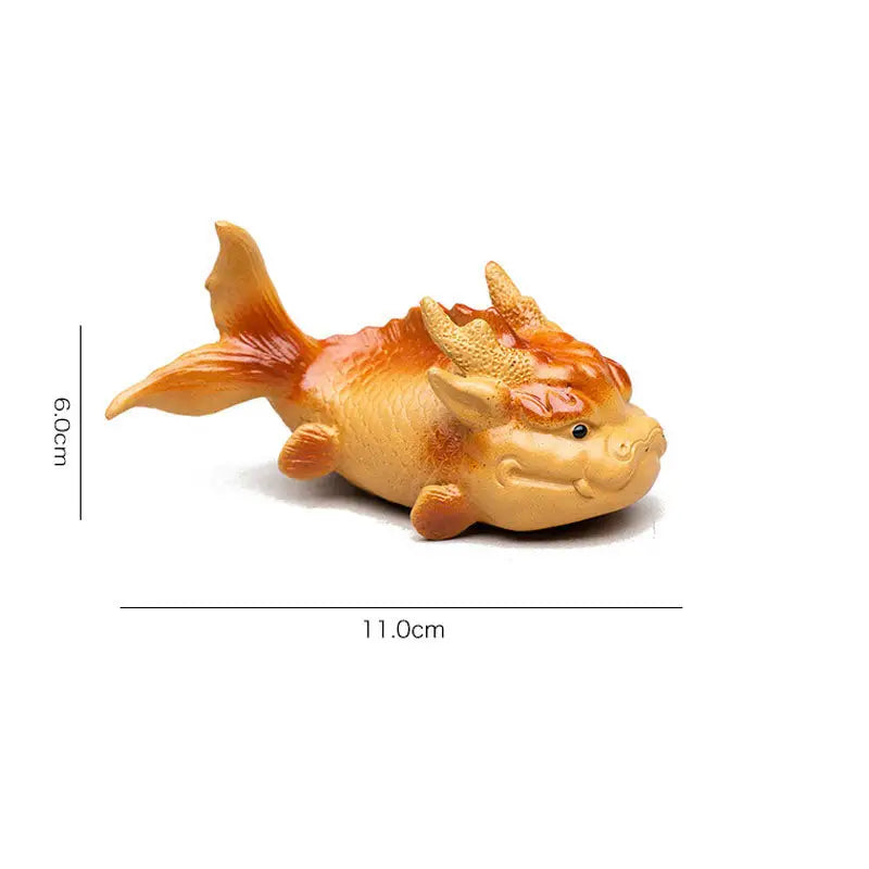 Orange fish-dragon figurine symbolizing feng shui good fortune in Prosperity Fish product
