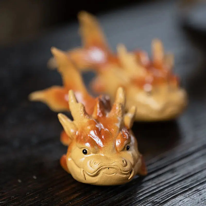 Wooden dragon figurines representing prosperity fish tea pet and feng shui good fortune