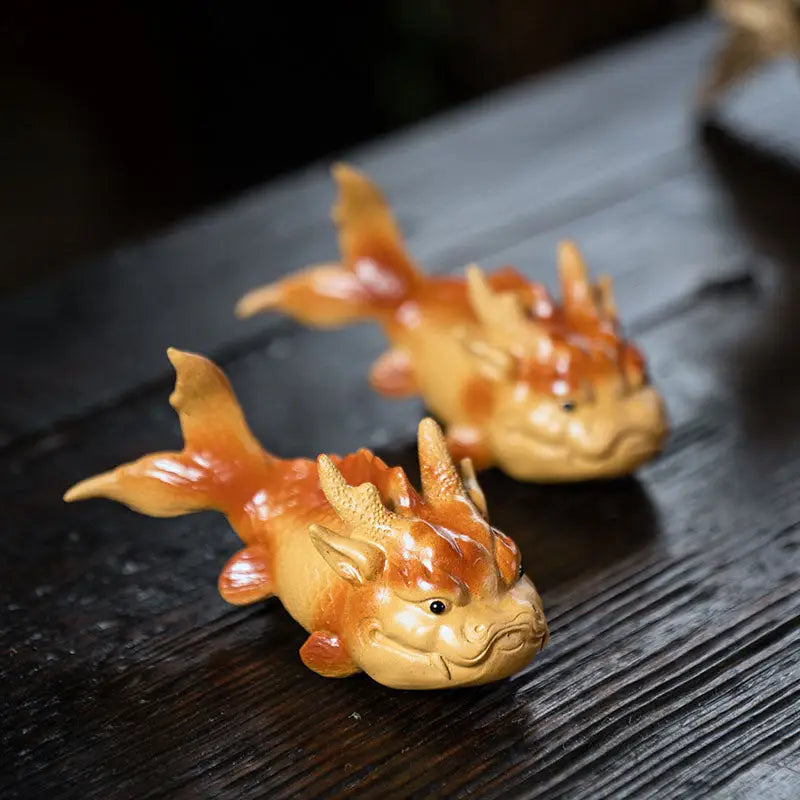 Two dragon-fish figurines of Prosperity Fish tea pet for feng shui good fortune