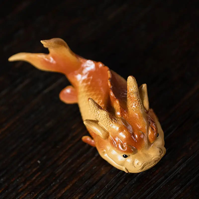 Orange and tan fish-dragon figurine representing love symbol fish tea pet for feng shui good fortune