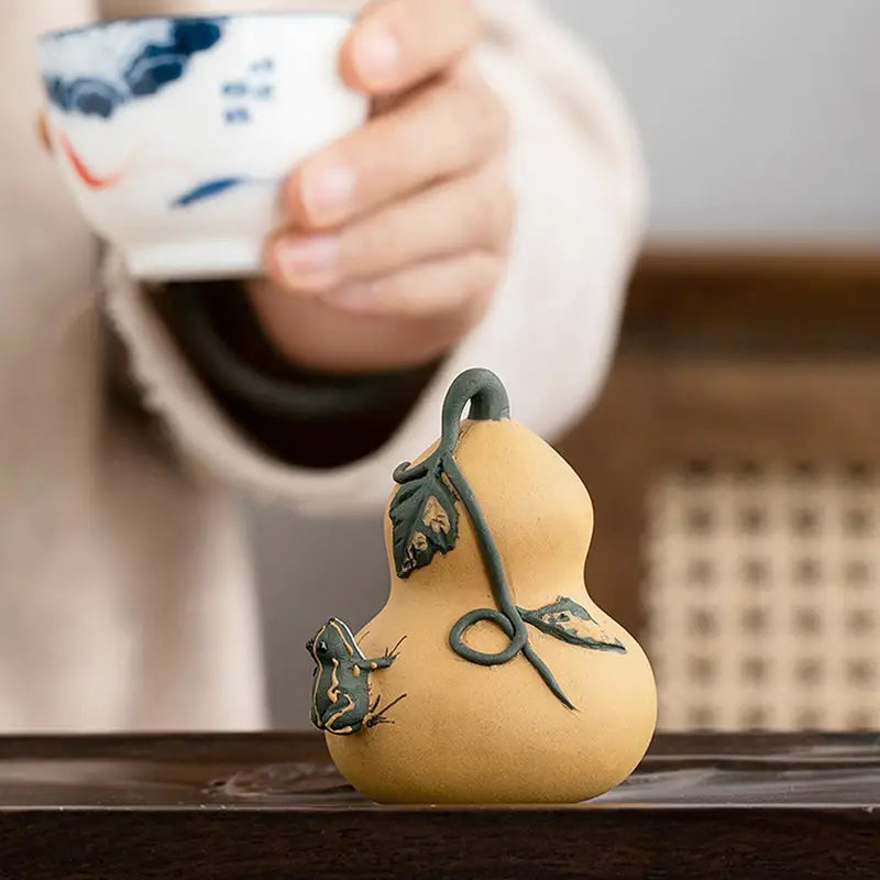 Prosperity Gourd ceramic tea pet with frog and vine details in Yixing clay, perfect for tea pets guide