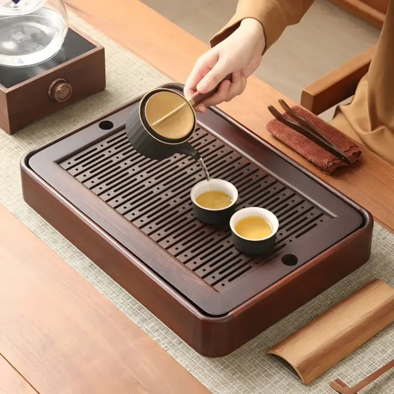 Quiet Stream bamboo tea tray with tea being poured, minimalist wooden tea tray