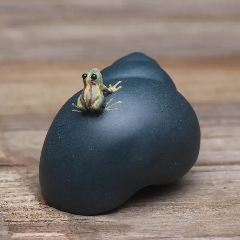 Raincaller Frog figurine on dark blue shell, perfect tea pet guide for yixing clay teapot
