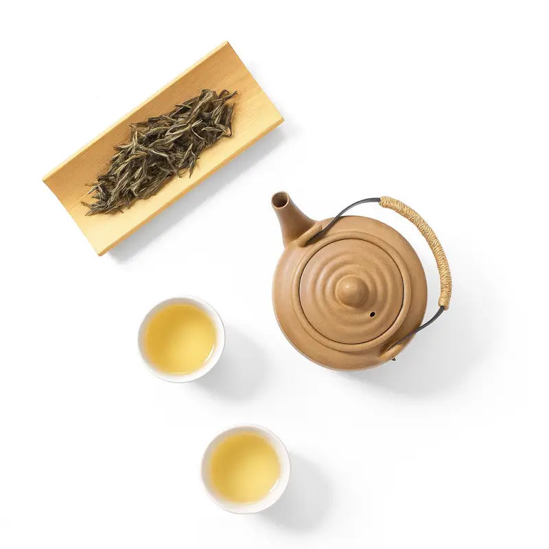 Tea set with teapot and cups of xiaoxiangshui raw pu-erh orchid fragrance tea from Ice Island region