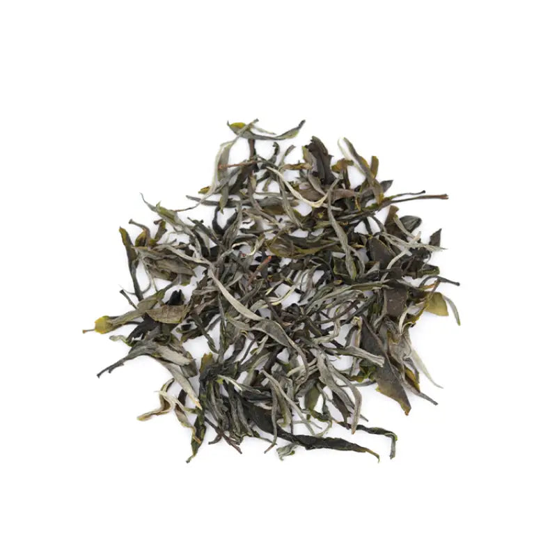 Pile of dried tea leaves from Ice Island Region featuring Xiaoxiangshui Raw Pu-erh and orchid fragrance tea