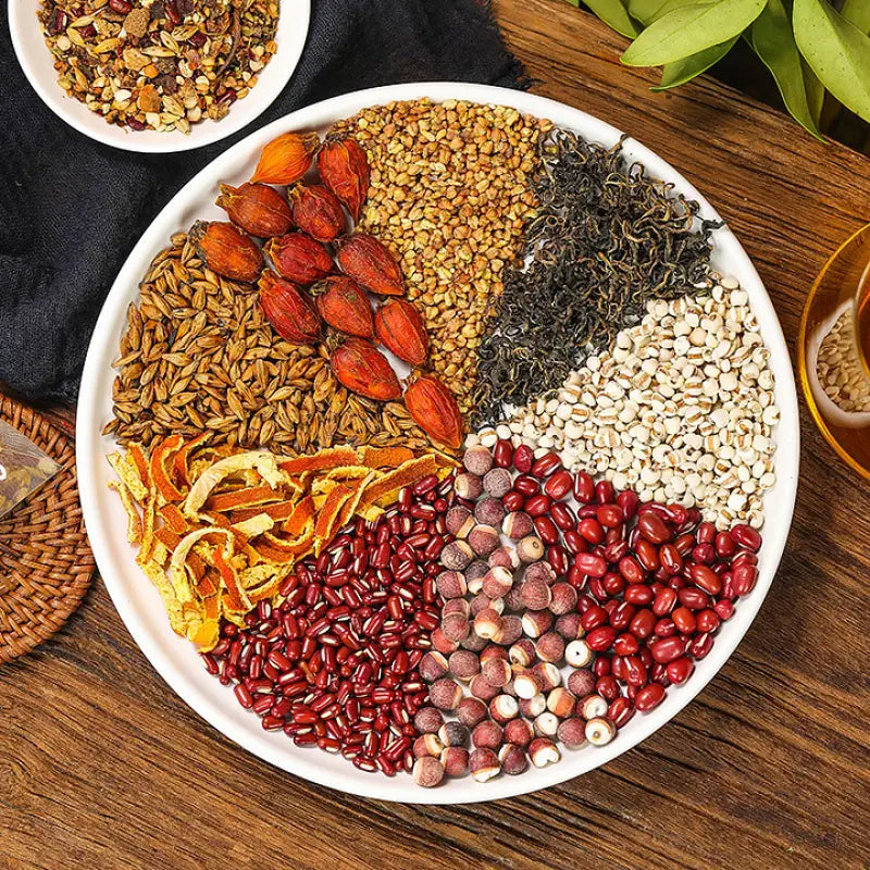 Assorted grains and dried fruits on a plate supporting detoxification in herbal tea for detox