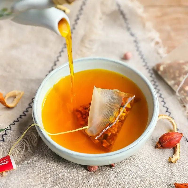 Tea being poured into a cup with tea bag, supporting detoxification and tangerine peel benefits