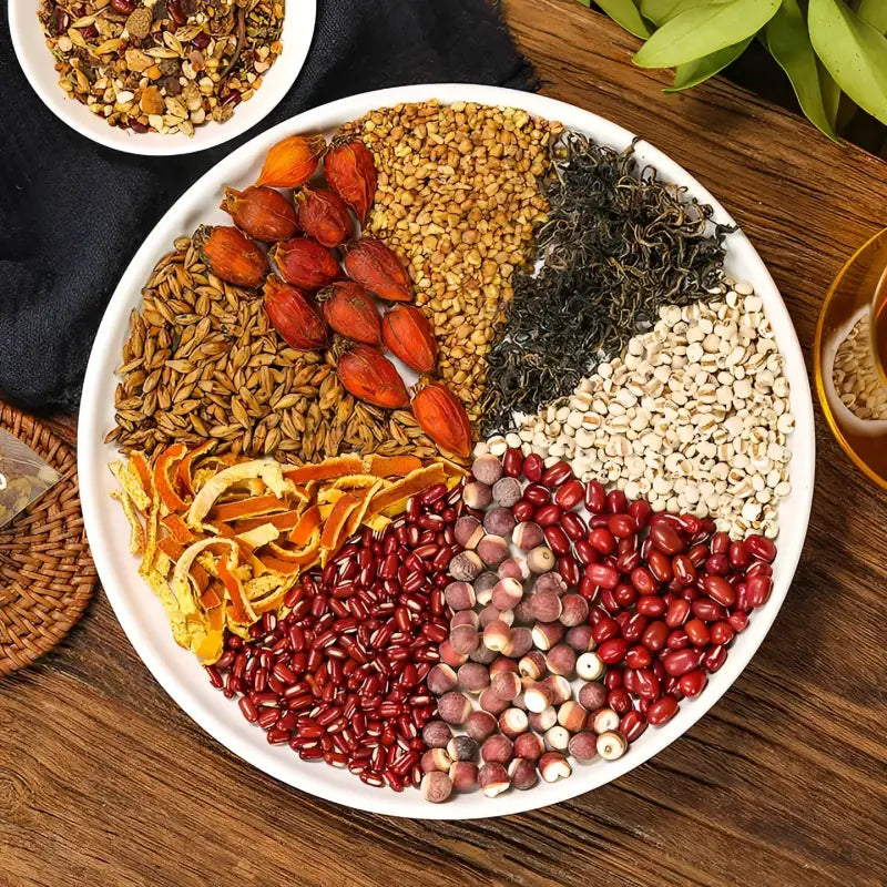 Assorted grains and dried fruits on a plate supporting detoxification in herbal tea for detox