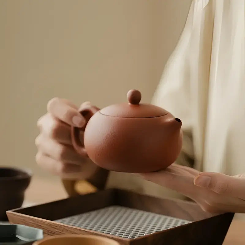 Round brown ceramic teapot from Red Harmony Yixing Zisha collection