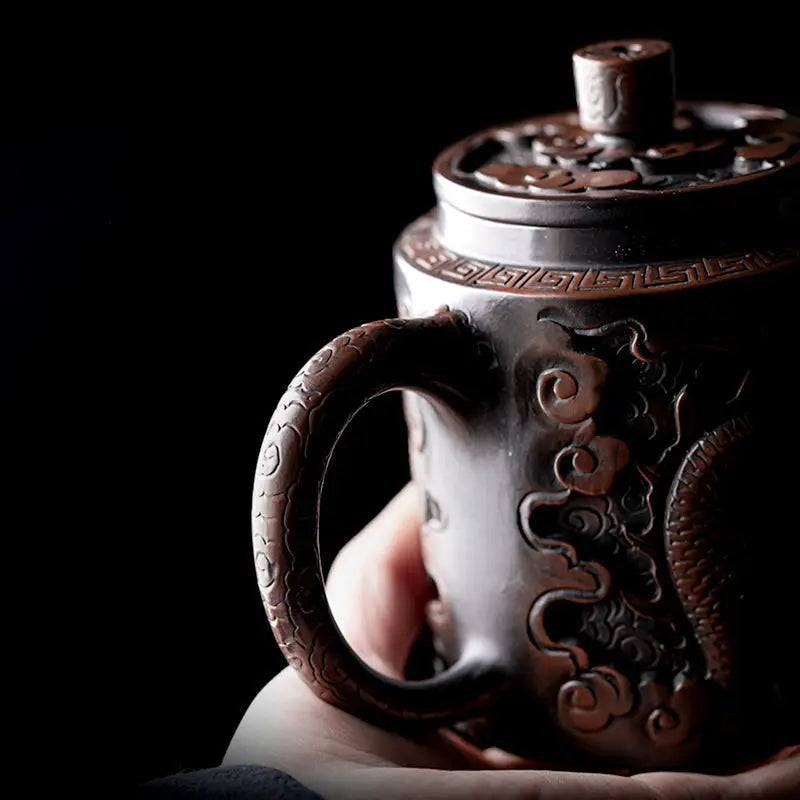 Ornate dark metal Relief Dragon teapot with dragon motif, ideal for jianshui zitao clay brewing