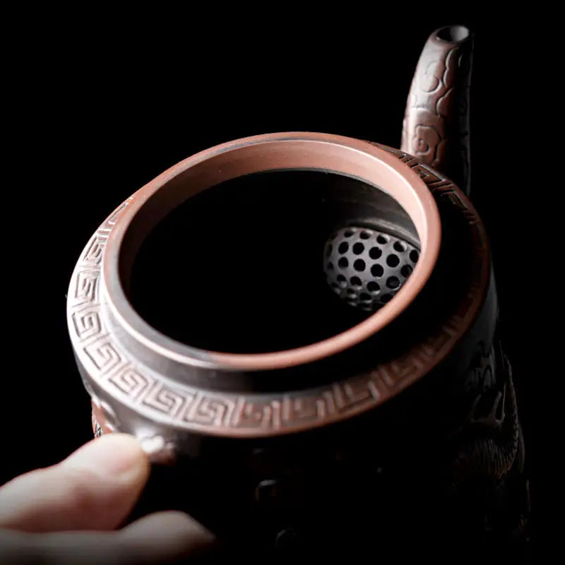 Ornate copper Relief Dragon Teapot crafted from Jianshui Zitao clay with dragon design
