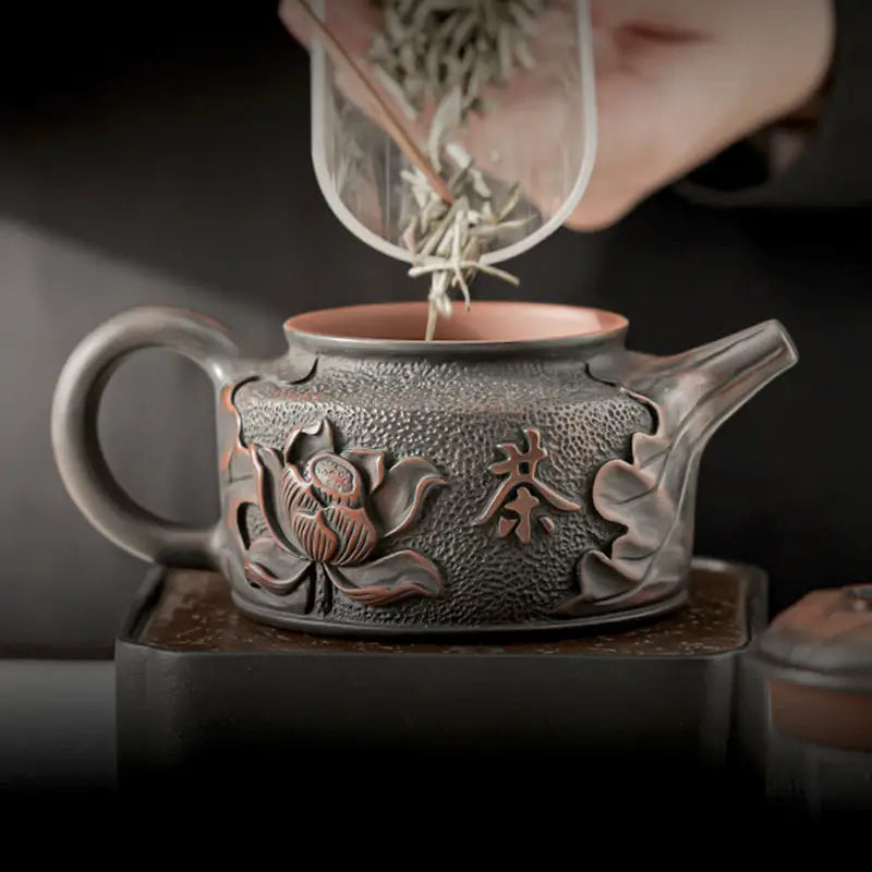 Relief Lotus ornate gray teapot made of Jianshui Zitao black clay for exquisite tea brewing