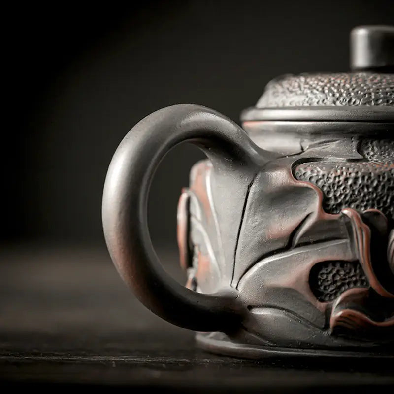 Relief Lotus ornate dark ceramic teapot made from Jianshui Zitao black clay