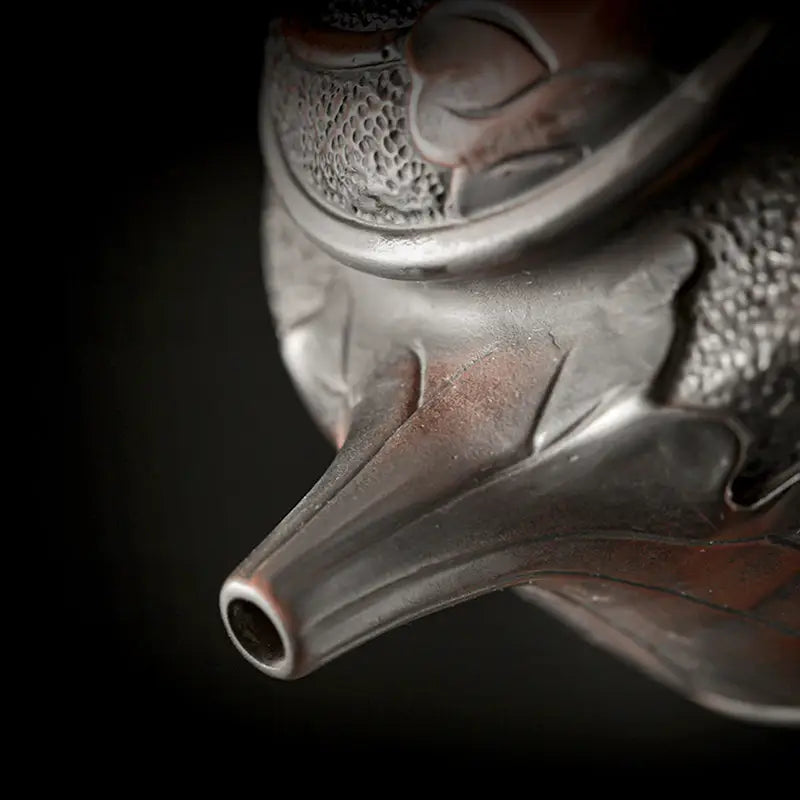 Relief Lotus ornate metal teapot spout showcasing jianshui zitao black clay craftsmanship