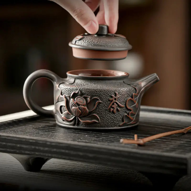 Relief Lotus ornate brown teapot with lid made from Jianshui Zitao black clay