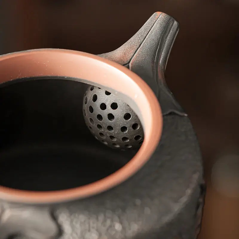 Relief Lotus black clay teapot with copper rim and perforated ball, Jianshui Zitao style