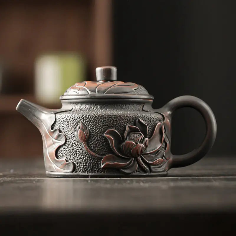 Ornate Black Clay Relief Lotus Jianshui Zitao Teapot with Lotus Flower Design