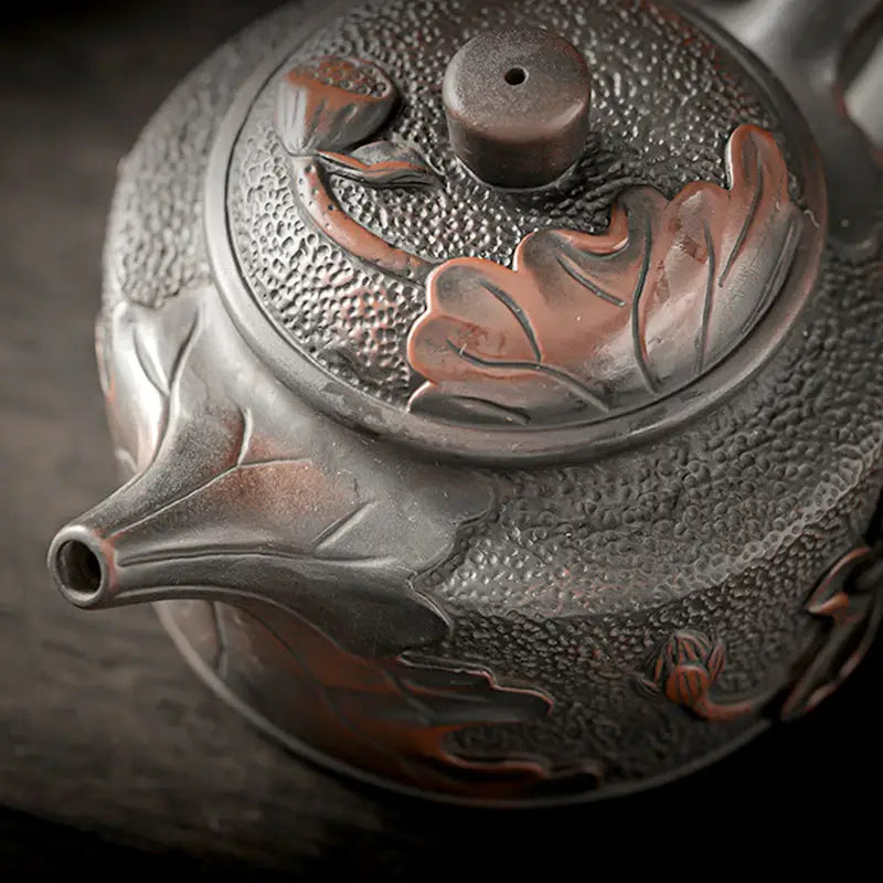 Ornate Relief Lotus Jianshui Zitao black clay teapot with intricate design