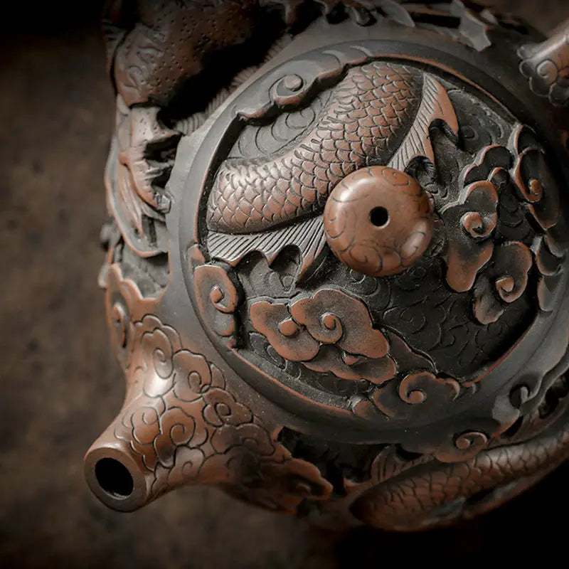 Ornate bronze Roaring Dragon jianshui zitao teapot with hand-carved dragon motif
