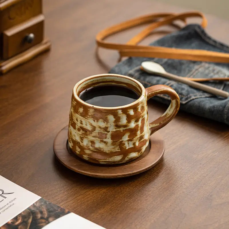 Rust Coffee Cup ceramic mug with handmade Dehua ceramic glaze and unique oxidation on a wood saucer